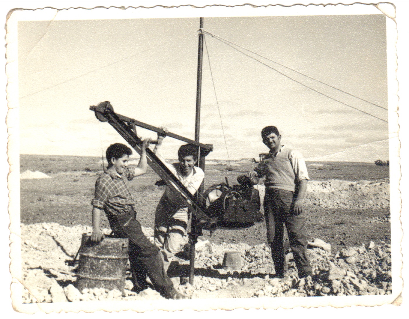 Elias, Peter and Emmanuel Christianos at a windlass over a shaft, Eight Mile field, circa 1958