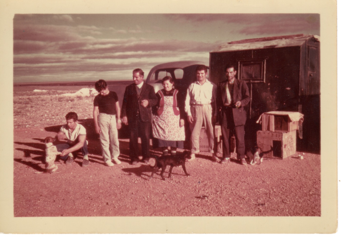 The Christianos family beside their truck and hut at the Eight Mile opal field, Coober Pedy, circa 1958