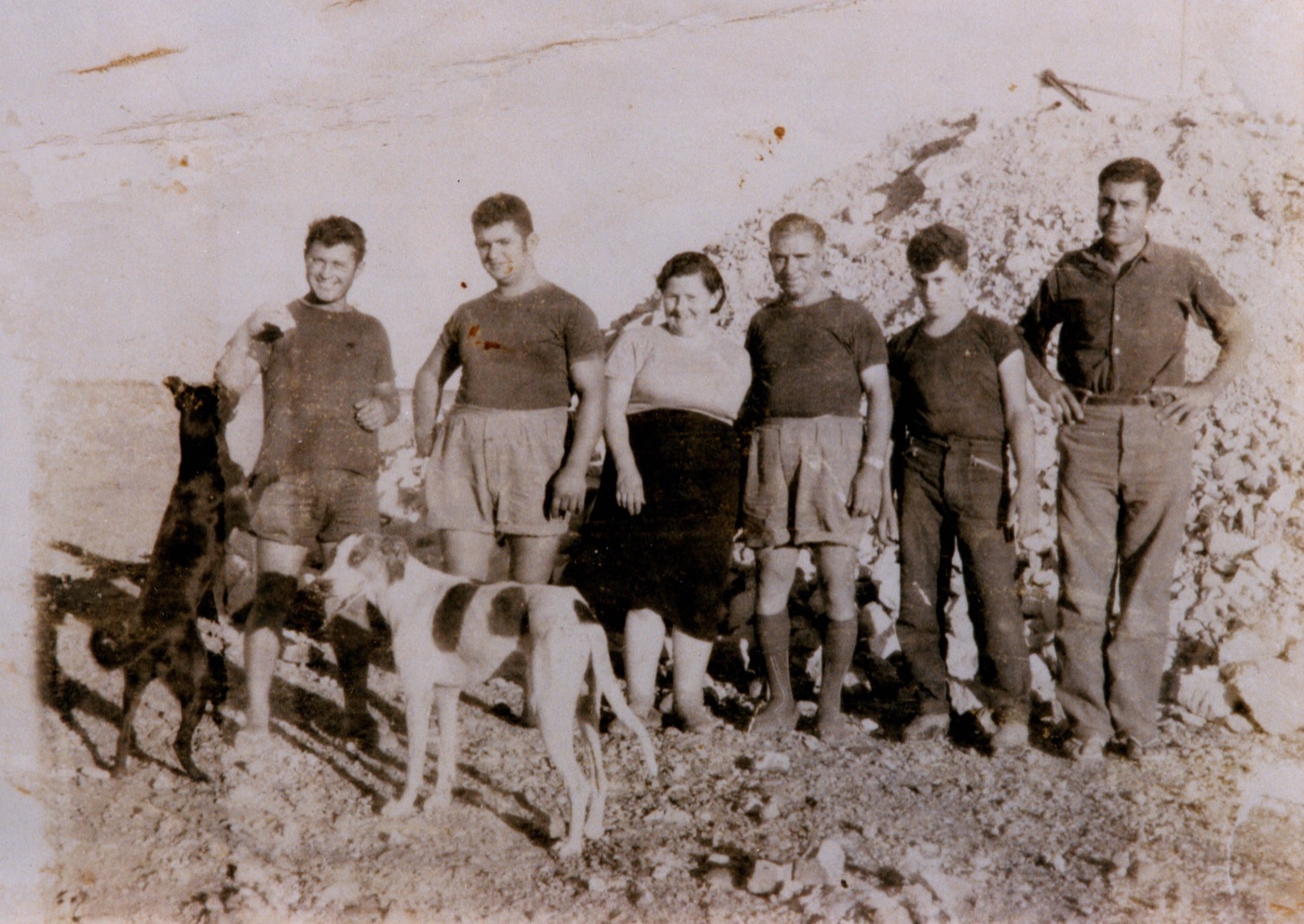 Family line-up with dogs in front of a mullock heap at the Eight Mile field, circa 1958