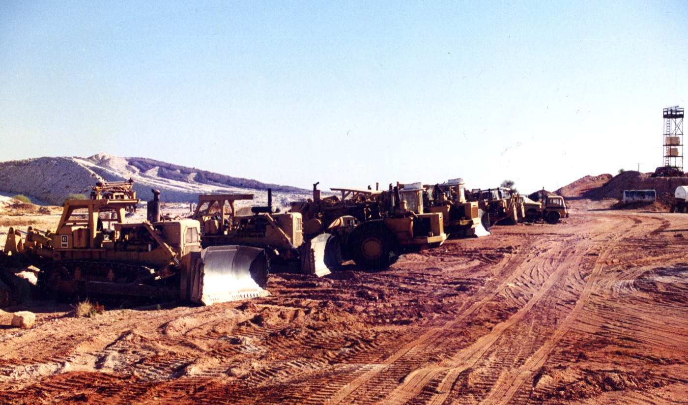 The Christianos machinery fleet lined up at Mintabie — D9 bulldozers, scrapers and loaders